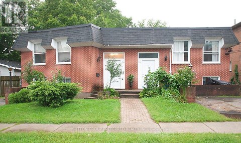 A red brick house with a white door and windows.