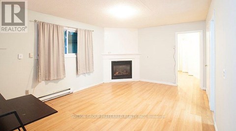 A living room with a fireplace and a dining table.