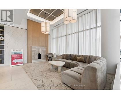 A living room with a couch, a fireplace, and a sign that says "PRE-REGISTERED".