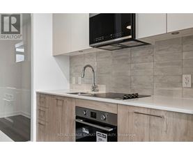 A modern kitchen with a microwave oven mounted above the stove.