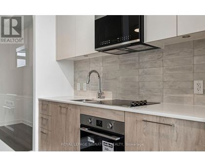 A modern kitchen with a microwave oven mounted above the stove.