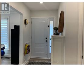 A living room with a drum set on the floor.