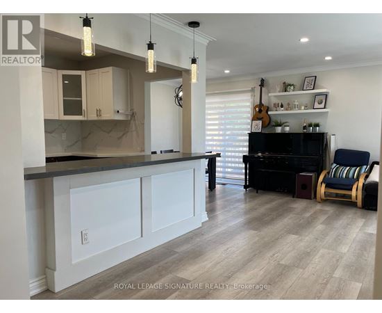 A well-lit kitchen with a bar area and a piano.