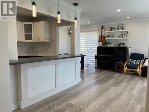A well-lit kitchen with a bar area and a piano.