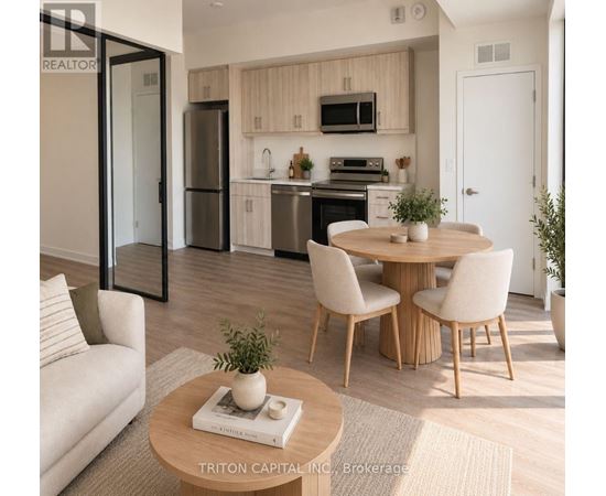 A modern kitchen with a dining table set up with chairs.