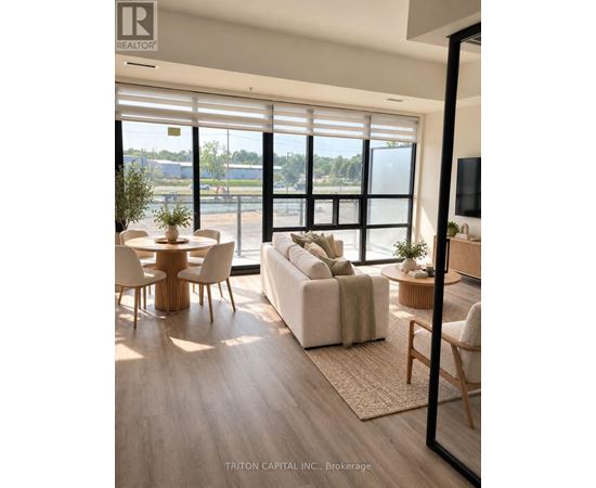 A modern living room with a large window and a view of the outside.