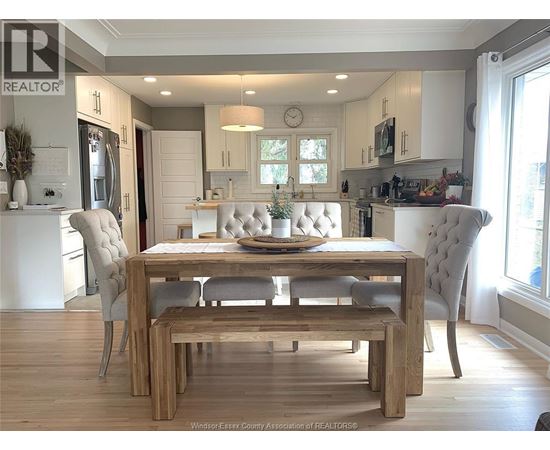 A dining room with a wooden table and chairs.