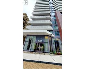 A tall building with a glass entrance and the number 4065 on it.