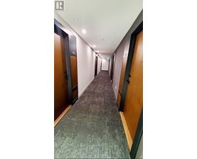 A long hallway with doors on both sides.