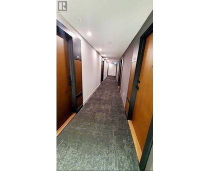 A long hallway with doors on both sides.