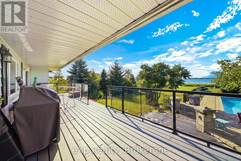 A deck with a pool and a hot tub.
