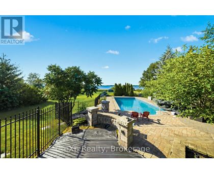 A backyard with a pool and a fence.