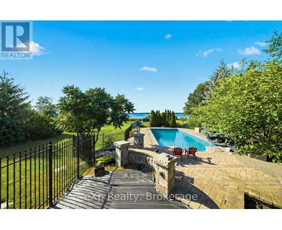A backyard with a pool and a fence.