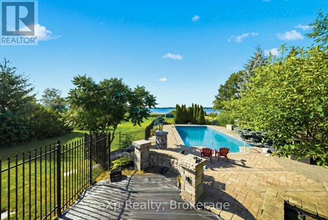 A backyard with a pool and a fence.