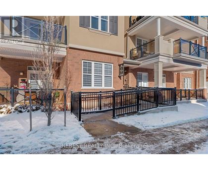 A snow-covered front yard of a multi-story apartment building.