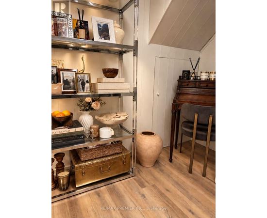 A shelf with various decorative items is displayed in a room.
