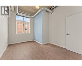 A room with a window and a door is available for rent.