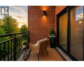 A balcony with a chair and a table with flowers on it.