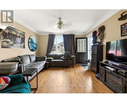 A living room with a grey couch and a black coffee table.