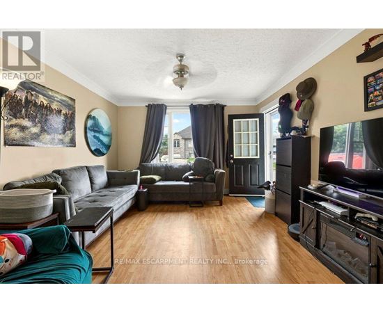A living room with a grey couch and a black coffee table.