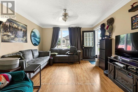 A living room with a grey couch and a black coffee table.