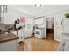 A kitchen with white cabinets and a brown countertop.