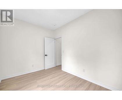 A room with a white door and a white wall.