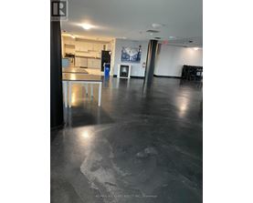 A large open space with a kitchen area in the background.