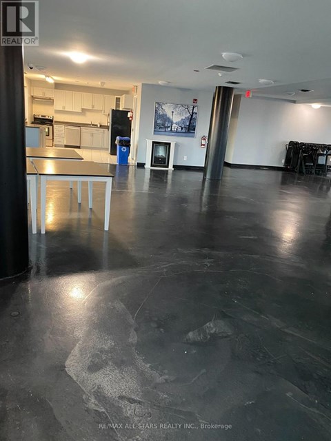 A large open space with a kitchen area in the background.