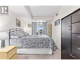 A bedroom with a bed, nightstand, and a dresser.