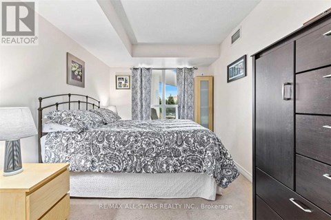 A bedroom with a bed, nightstand, and a dresser.