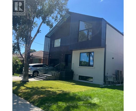 A modern house with a dark brown and white exterior is for sale.