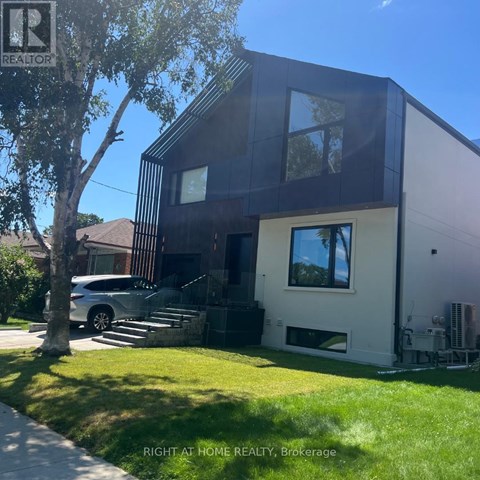 A modern house with a dark brown and white exterior is for sale.