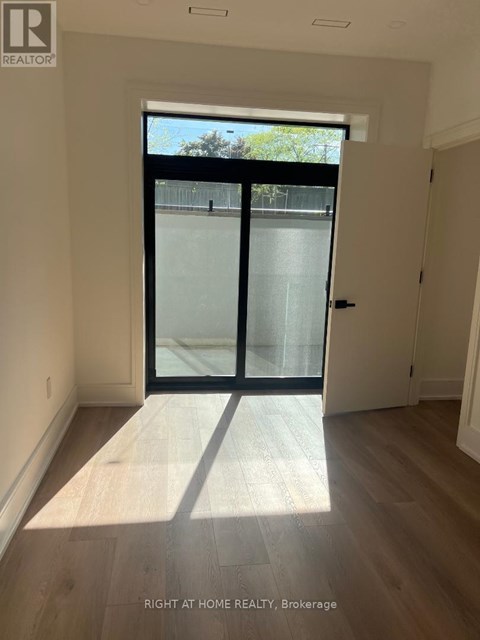 A room with a glass door leading outside.