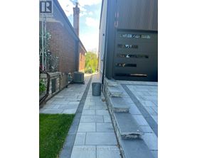 A stone pathway leads to a garage.