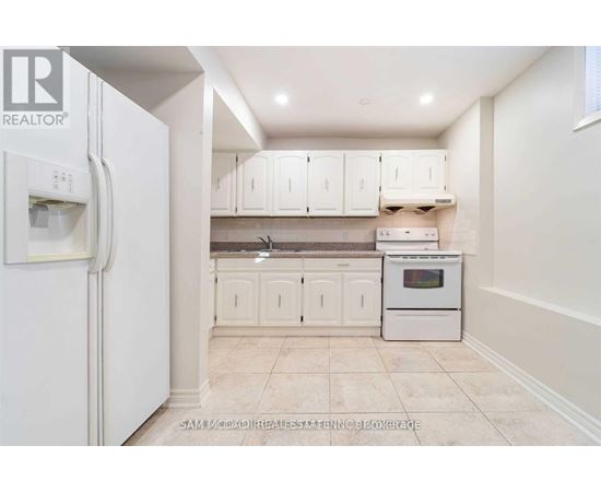 A kitchen with white cabinets and appliances.