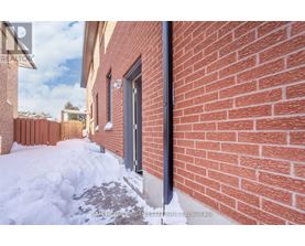 A red brick wall with a black pipe running along it.