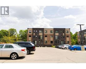 A parking lot with cars and a building in the background.