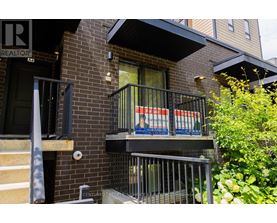 A balcony with a metal railing and a sign that reads "REALTOR".