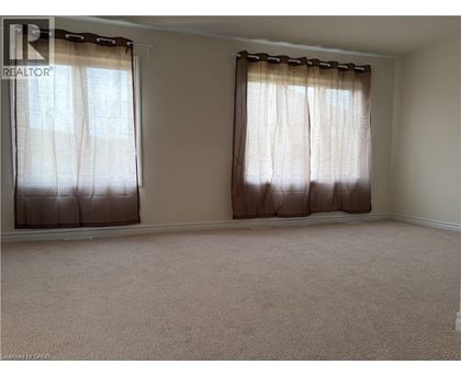 A room with a window covered by brown curtains.