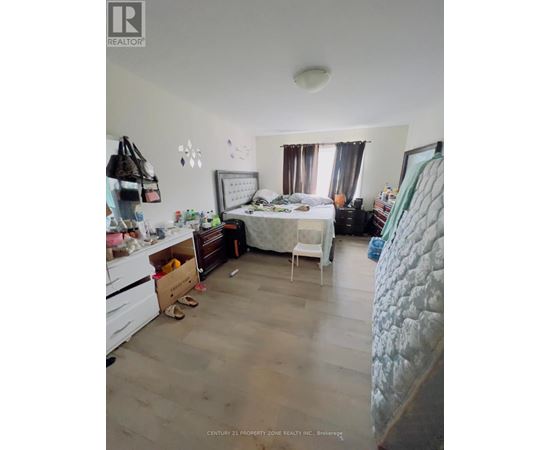 A bedroom with a bed, dresser, and chair.
