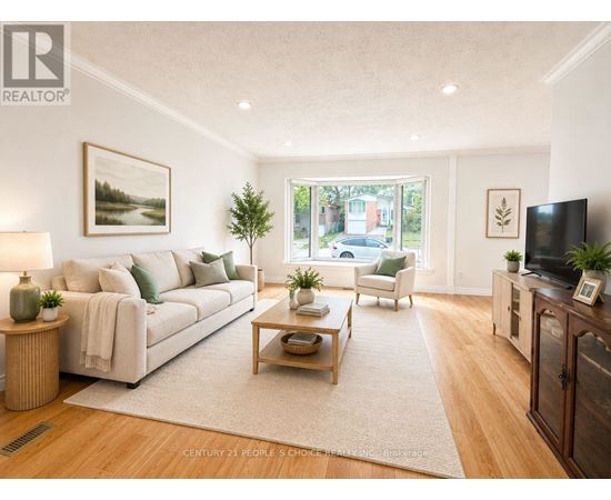 A living room with a white couch and a wooden coffee table.