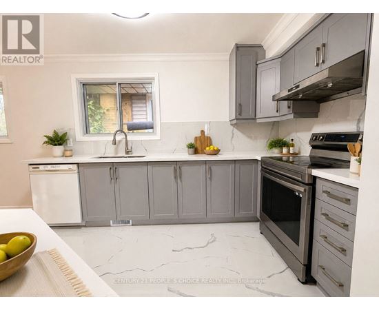 A modern kitchen with grey cabinets and a white dishwasher.