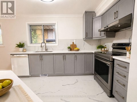 A modern kitchen with grey cabinets and a white dishwasher.