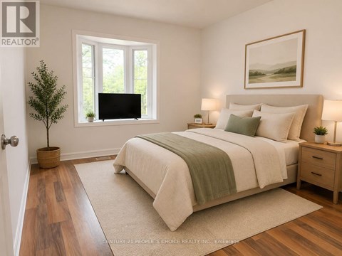 A bedroom with a large bed, a small tree, and a painting on the wall.