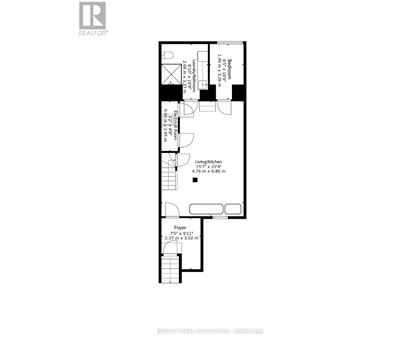 A floor plan of a living space with a kitchen, foyer, and bathrooms.