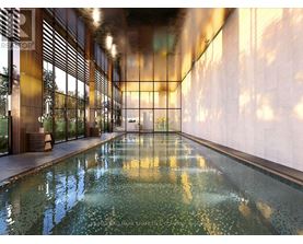 A long hallway with a pool in the middle and a wall on the right.