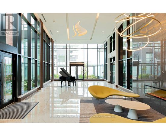 A piano is in the middle of a room with a lot of windows.