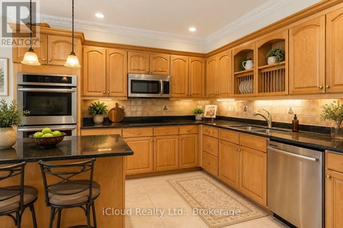 A kitchen with wooden cabinets and a black countertop.