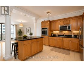 A kitchen with wooden cabinets and a black countertop.